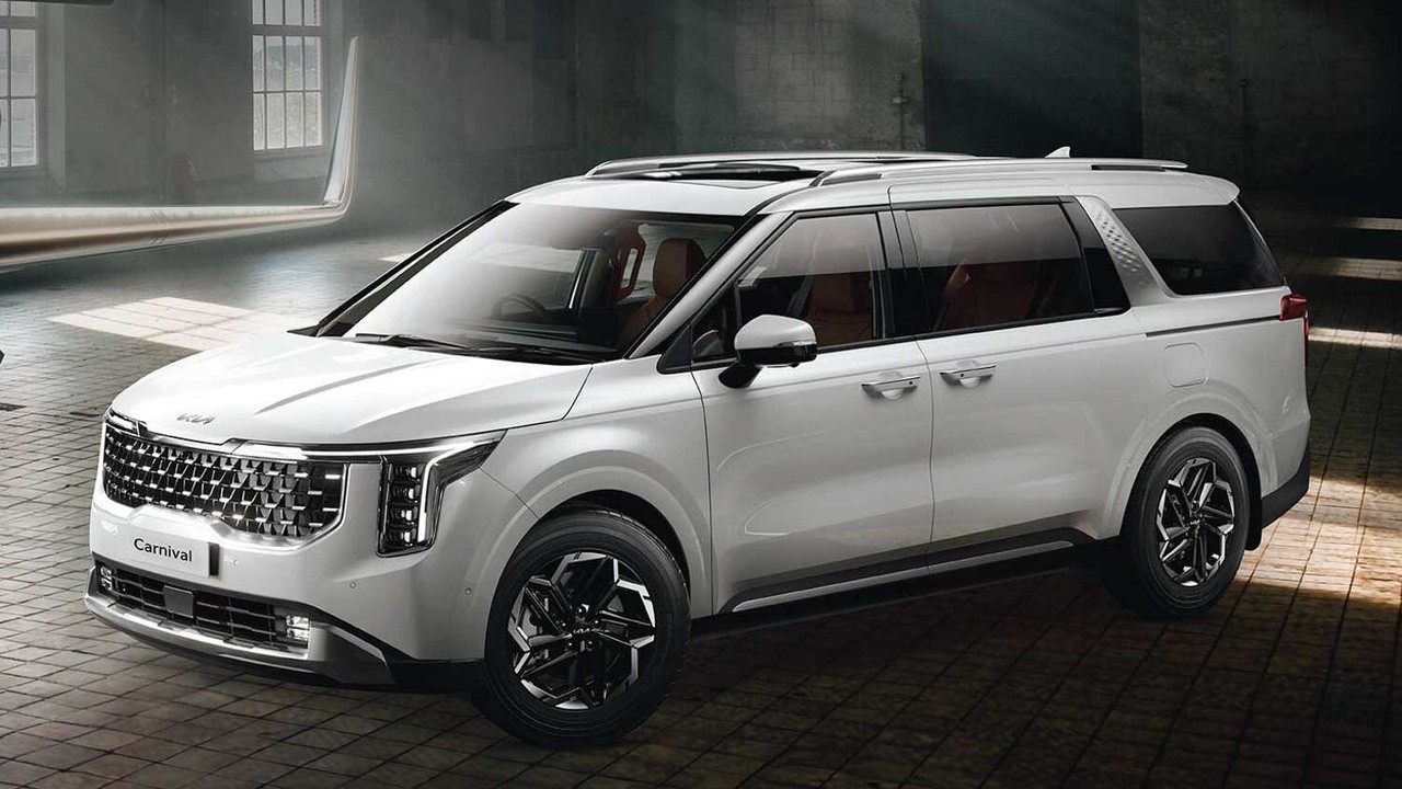 सफेद रंग की Kia Carnival Hybrid लग्ज़री MPV का फ्रंट थ्री-क्वार्टर व्यू